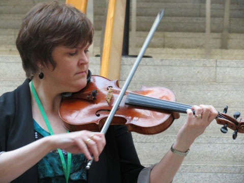 Margaret Scollay, playing her fiddle